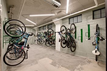 A bike rack with many bikes hanging on it